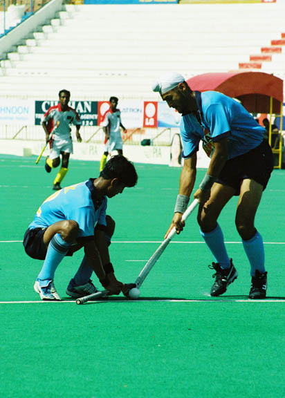 Sandeep Singh drag flicking the ball